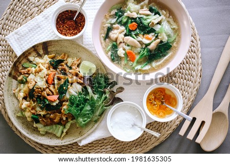 Stir fried noodle in soy sauce with pork - Pad-Se-ew Moo , Thai Noodles in Thick Gravy. Traditional Thai food 
