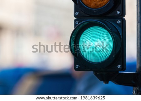 closeup of traffic semaphore with green light on defocused city street background with copy space Royalty-Free Stock Photo #1981639625