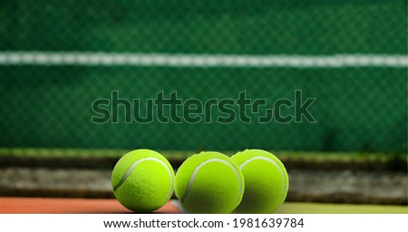 Composition of three tennis balls on tennis court with copy space. sport and competition concept digitally generated image.