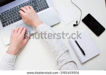 Hands on lapton, working time. Work concept. Laptop, smartphone and lapel microphone on a white background
