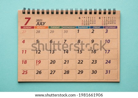 July 2021 desk calendar on green background