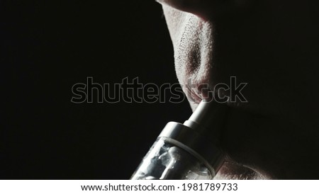Closeup photo of smoker man on black