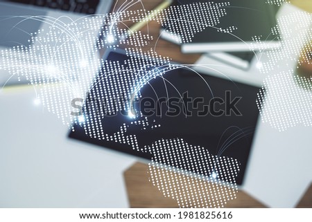 Double exposure of abstract digital world map with connections and digital tablet on background, top view, research and strategy concept