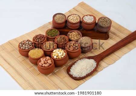 Multi grains nicely arranged in a ethenic pots with wood spoon HD quality studio shoot for advertising agency     Royalty-Free Stock Photo #1981901180