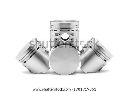 Four new pistons for engine isolated on white background. Car spare parts. Royalty-Free Stock Photo #1981919861