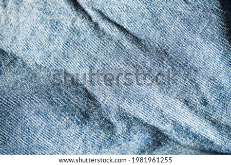 Denim texture of blue jean with copy space. Close up grunge and wrinkle Indico color fabric. Royalty-Free Stock Photo #1981961255