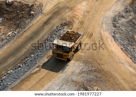 aerial shot excavator and dump truck in one of the stone work hard at quarry transpotation construction concept . with copy space.