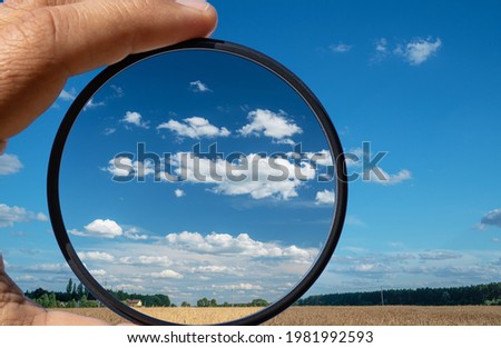 Effect of a polarizing filter shown on the photo of the sky. The picture of the clouds is higher contrast through the filter. Royalty-Free Stock Photo #1981992593