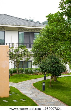 A corner of the villa’s backyard garden, stone paths and green plants