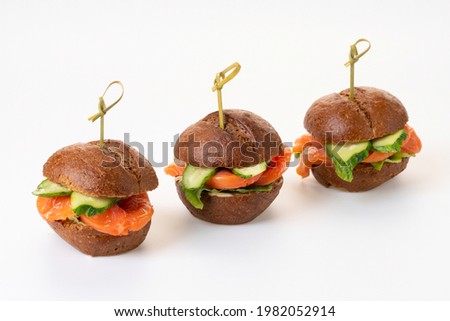 Mini burgers with salmon. Catering. On a white background