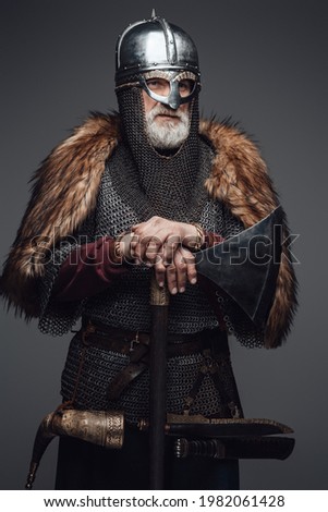 Barbaric elder viking with helmet fur and mail Royalty-Free Stock Photo #1982061428