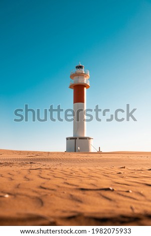 "Fangar" lighthouse situated in Ebro Delta beach. Picture taked in a sunny with a clear blue sky.