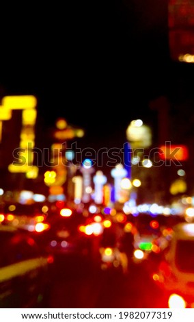 A blurred bokeh of the city lights and traffic at the downtown. Bokeh background.