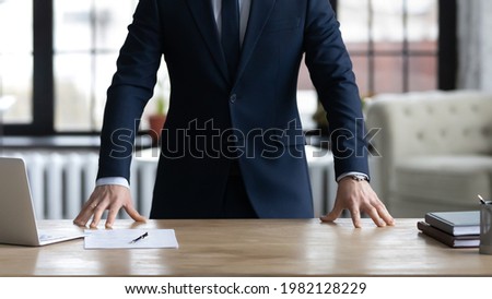 Company executive, CEO, owner in formal suit standing at work desk, ready to start meeting, interview, negotiation. Cropped shot of confident proactive business leader. Leadership concept. Close up Royalty-Free Stock Photo #1982128229