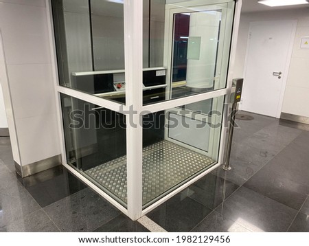Large new inclusive elevator in the metro or shopping center for people with disabilities and people with disabilities for a barrier-free city environment.
