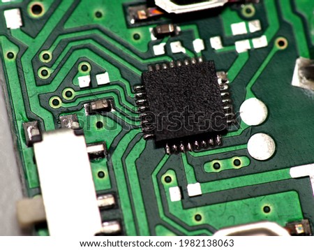 Green Printed Circuit Board (PCB) with some Surface Mount Device (SMD) components and chips. Shoot on white isolated background.