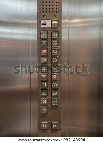 Buttons for getting up and down the elevator on the stainless steel wall