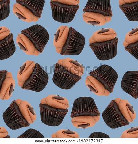 Seamless pattern made of chocolate cupcakes scattered throughout the image. The background color is blue.