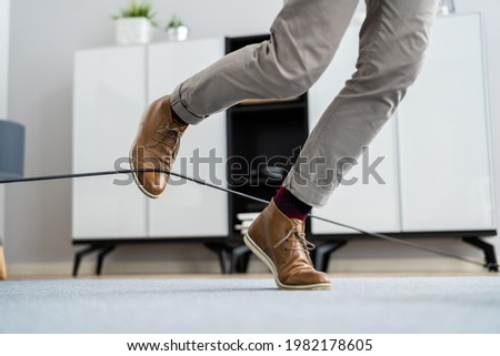 Wire Cord Trip Over And Fall. Feet Stumble On Cable Royalty-Free Stock Photo #1982178605