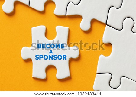 Become a sponsor message on a puzzle piece apart form the assembled pieces. Financial sponsorship support or charity donation concept.

 Royalty-Free Stock Photo #1982183411