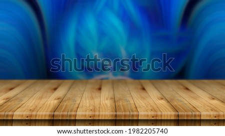 An empty brown wooden table and a beautiful blue abstract blur background, can be used to montage or show off your product