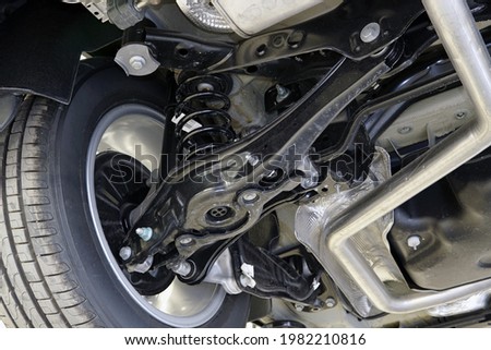 The structure and suspension elements of a modern car. Car service, repair and spare parts for cars. Royalty-Free Stock Photo #1982210816