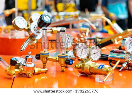 Pressure gauge regulator manometer and cylinder content capacity gauge and argon flow meter equipment for acetylene oxygen gas tig mig welding or cutting in industrial on table Royalty-Free Stock Photo #1982265776