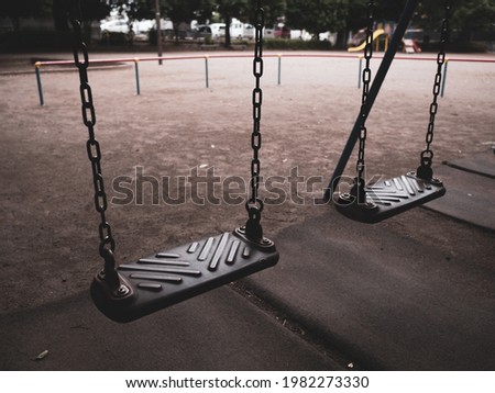 An empty park and old swings. Royalty-Free Stock Photo #1982273330