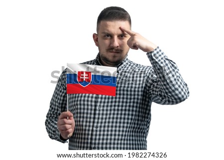 White guy holding a flag of Slovakia and a finger touches the temple on the head isolated on a white background.