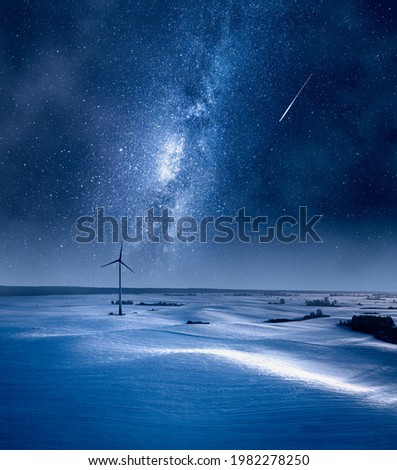 Milky way over wind turbine at night. Alternative energy in winter, Poland. Aerial view of nature in Poland Royalty-Free Stock Photo #1982278250