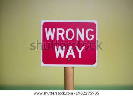 Conceptual wrong way sign post. Warning sign of wrong way. 