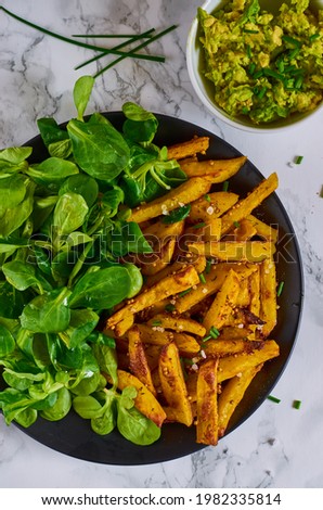 fries with corn salad on the plate