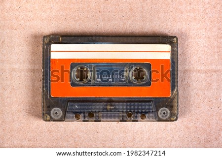 Old Audio Cassette on the Cardboard Background closeup