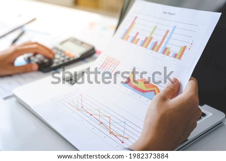 woman accountant doing finance and calculate on a desk about cost at the home office. finance accounting concept