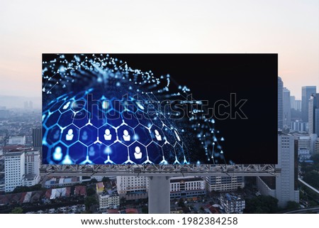 Glowing Social media icons on billboard over sunset panoramic city view of Kuala Lumpur, Malaysia, Asia. The concept of networking and establishing new connections between people and businesses in KL
