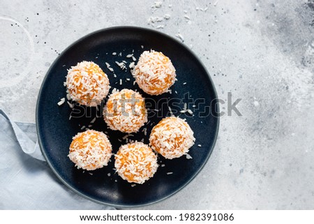 apricot coconut protein balls in blue bowl. vegan alternative food. copy space. top view. selective focus Royalty-Free Stock Photo #1982391086