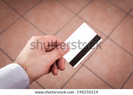 Closeup of a hand holding up a credit card real situation