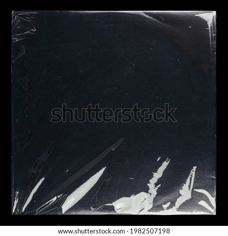 Transparent plastic wrap on the black background. Clean blank texture overlay effect template. Isolated wrinkle surface branding mock-up template. Royalty-Free Stock Photo #1982507198