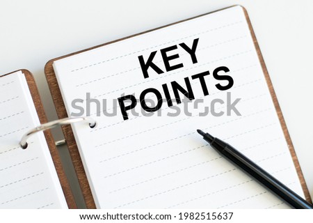 key points, text on white notepad on white background near black marker