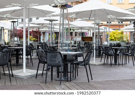 Beautiful outdoor cafe with small  tables and wicker chairs, Riga, Latvia