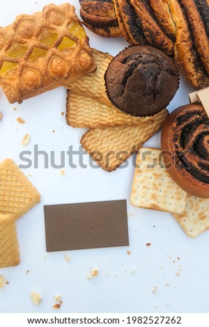 Assorted pastries goods mockup with white empty business card