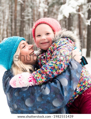 a woman plays with her children with snow. winter fun