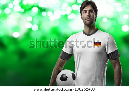 German soccer player, celebrating on a green lights  background.