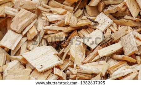 sawdust after wood processing, secondary raw materials Royalty-Free Stock Photo #1982637395