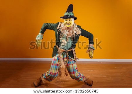 photo of scarecrow character from festa junina on yellow background with space for text