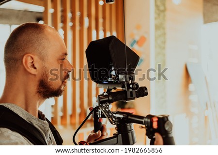 Cameraman working on professional camera taking stock footage