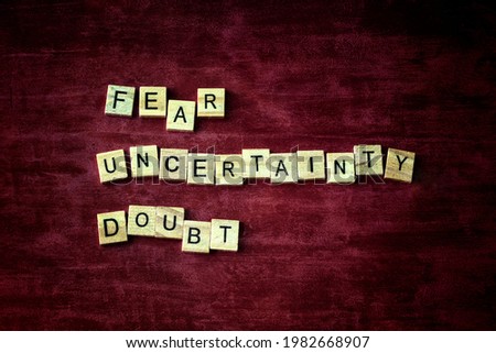 Blocks of 'Fear', 'Uncertainty', and 'Doubt', FUD concept in sales, marketing, public relations, politics, polling and cults. Royalty-Free Stock Photo #1982668907