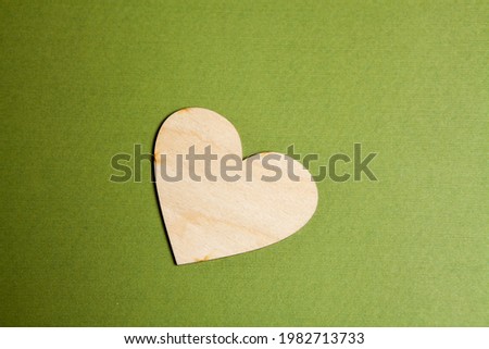 wooden heart on a green background