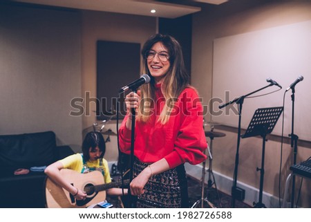 Music band performing in a recording studio - young woman singer rehearsing - practice, vocalist, song concept