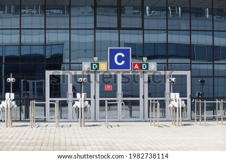 Glass doors and turnstiles, entrance to the indoor stadium arena, airport. No people or visitors. Terminal.